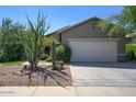 Single story home with desert landscaping and two-car garage at 40702 N Robinson Dr, Anthem, AZ 85086