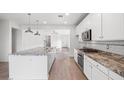 Spacious kitchen with white cabinets and granite island at 21451 W Palm Ln, Buckeye, AZ 85396