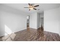 Large bedroom with hardwood floors and access to bathroom at 21451 W Palm Ln, Buckeye, AZ 85396