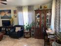 Living room with ample natural light and a decorative china cabinet at 303 N 7Th St, Avondale, AZ 85323