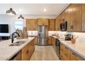 Modern kitchen with stainless steel appliances and wood cabinets at 22511 E Saddle Ct, Queen Creek, AZ 85142