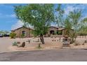 House with a large front yard, mature trees and circular driveway at 35140 N 52Nd Pl, Cave Creek, AZ 85331