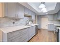 Modern kitchen featuring gray cabinets, quartz countertops, and tile backsplash at 292 Leisure World --, Mesa, AZ 85206