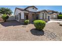 House exterior with stone accents and desert landscaping at 19741 E Reins Rd, Queen Creek, AZ 85142