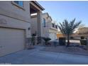 Two story house with tan exterior, balcony, and attached garage at 44973 W Sandhill Rd, Maricopa, AZ 85139