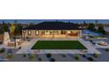 Backyard oasis with firepit, lawn, and outdoor dining area at 1896 E Cloud Rd, Phoenix, AZ 85086