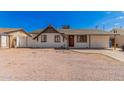 Ranch-style home with a gravel yard and chain link fence at 6629 W Rose Ln, Glendale, AZ 85301