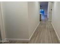 Bright hallway with wood-look flooring at 46137 W Starlight Dr, Maricopa, AZ 85139