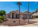 Single-story home with a two-car garage and rock landscaping at 2830 S Arroyo Ct, Chandler, AZ 85286