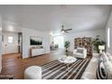 Bright living room features hardwood floors, comfy seating, and a view into the dining area at 9501 E Broadway Rd # 132, Mesa, AZ 85208