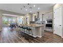 Modern kitchen with island, stainless steel appliances, and breakfast bar at 32269 N 133Rd Dr, Peoria, AZ 85383