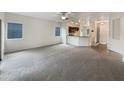 Spacious living room with carpeted flooring and access to the kitchen at 432 W Flame Tree Ave, San Tan Valley, AZ 85140