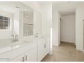 Bright bathroom with double vanity, large mirror, and tile flooring at 37375 W Patterson St, Maricopa, AZ 85138
