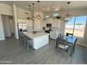 Open concept kitchen with island, dining area, and stainless steel appliances at 13415 S Hermit Rd, Buckeye, AZ 85326