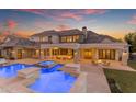 Luxury home with a stunning pool, spa, and outdoor entertaining area at 20664 E Ivy Ln, Queen Creek, AZ 85142