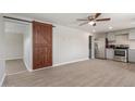 Modern kitchen featuring stainless steel appliances and a stylish barn door at 9424 N 2Nd Pl, Phoenix, AZ 85020