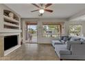 Living room with tile floors, fireplace and view of backyard at 42336 W North Star Dr, Maricopa, AZ 85138