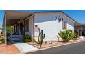 Nice single wide mobile home with covered porch and cacti at 11596 W Sierra Dawn Blvd # 196, Surprise, AZ 85378