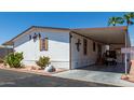 Single-wide mobile home with carport and desert landscaping at 11596 W Sierra Dawn Blvd # 196, Surprise, AZ 85378