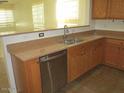 Kitchen with double sink and dishwasher at 43624 W Bailey Dr, Maricopa, AZ 85138
