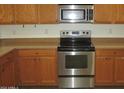 Stainless steel stove and microwave in kitchen at 43624 W Bailey Dr, Maricopa, AZ 85138