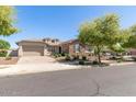 Beautiful one-story house with stone accents and landscaping at 13695 N 148Th Dr, Surprise, AZ 85379