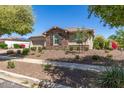 House exterior showcasing stone facade, landscaping, and driveway at 13695 N 148Th Dr, Surprise, AZ 85379