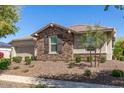 Single-story home with stone accents and a landscaped front yard at 13695 N 148Th Dr, Surprise, AZ 85379