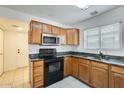 Kitchen with wood cabinets, granite counters, and appliances at 11634 W Olive Dr, Avondale, AZ 85392