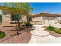 Tan colored stucco home with a three-step entry and mature tree at 26496 W Lone Cactus Dr, Buckeye, AZ 85396