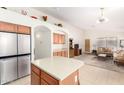 Modern kitchen with stainless steel appliances and an island with seating at 2420 W Blue Sky Dr, Phoenix, AZ 85085