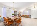 Dining area with a large table and chairs, situated near the living room at 2420 W Blue Sky Dr, Phoenix, AZ 85085