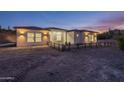 Luxury home exterior at dusk with desert landscape at 3555 W Hummingbird Ln, San Tan Valley, AZ 85144