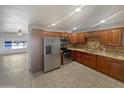 Bright kitchen with wood cabinets, granite counters & stainless steel appliances at 4026 W Rovey Ave, Phoenix, AZ 85019