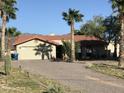 Single-story home with a two-car garage and desert landscaping at 423 S Arroya Rd, Apache Junction, AZ 85119