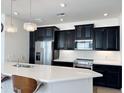 Modern kitchen with dark cabinets, white countertops, and island at 2511 W Queen Creek Rd # 417, Chandler, AZ 85248