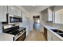 Updated kitchen with stainless steel appliances and quartz countertops at 3013 W Hearn Rd, Phoenix, AZ 85053