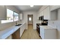 Bright kitchen with stainless steel appliances and quartz countertops at 3013 W Hearn Rd, Phoenix, AZ 85053