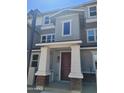 Townhome entrance with modern brown door and columns at 639 W Pepper Pl # 102, Mesa, AZ 85201