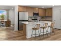Modern kitchen with island, stainless steel appliances, and light wood cabinets at 24367 W Jessica Ln, Buckeye, AZ 85326