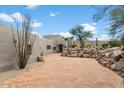 Brick paved driveway leading to a stucco home with desert landscaping at 23832 N 112Th Pl, Scottsdale, AZ 85255