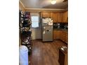 Eat-in kitchen with wood cabinets and appliances at 6321 N 65Th Dr, Glendale, AZ 85301
