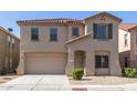 Two story house with tan exterior, red tile roof, and a two car garage at 9403 W Sheridan St, Phoenix, AZ 85037