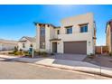 Modern two-story house with light-colored exterior and a brown garage door at 17975 W Vogel Ave, Goodyear, AZ 85338