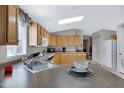 Kitchen features wood cabinets, gas range, and double sink at 201 S Greenfield Rd # 11, Mesa, AZ 85206