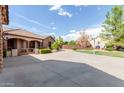 House exterior showcasing stone accents, gated entry, and a large driveway at 6918 E Granada St, Mesa, AZ 85207
