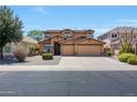 Two story house with three car garage and desert landscaping at 14867 W Windsor Ave, Goodyear, AZ 85395