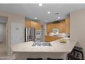 L-shaped kitchen with stainless steel appliances and an island at 42818 W Morning Dove Ln, Maricopa, AZ 85138