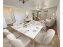 Bright dining room with hardwood floors and seating for six at 12059 W Carlota Ln, Sun City, AZ 85373