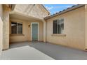 Inviting front entrance with light teal door and neutral colored stucco walls at 6020 W Yorktown Way, Florence, AZ 85132